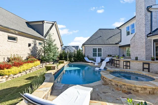 a view of a patio with table and chairs and potted plants