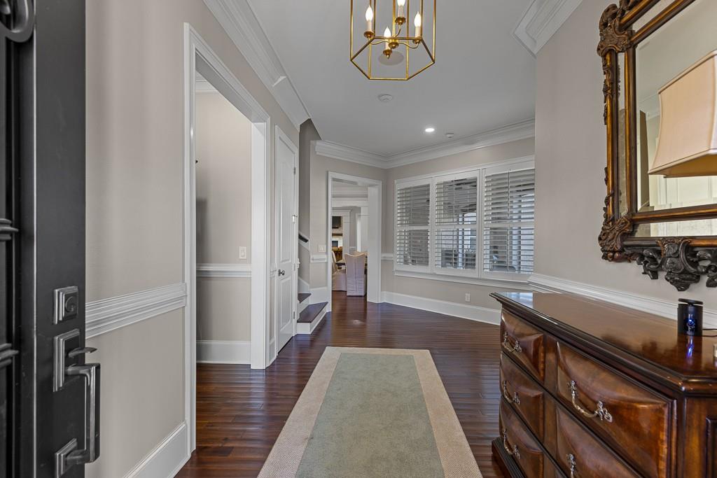 2794 Cork Street Hoschton, GA 30548 - Photo 9 of 51 a view of a hallway with wooden floor and staircase