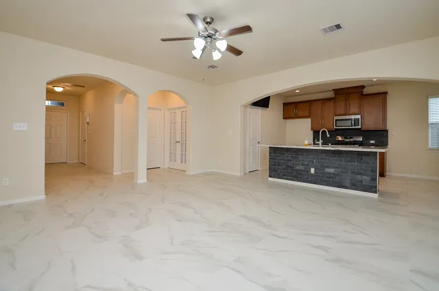 a view of a kitchen with a sink and a refrigerator