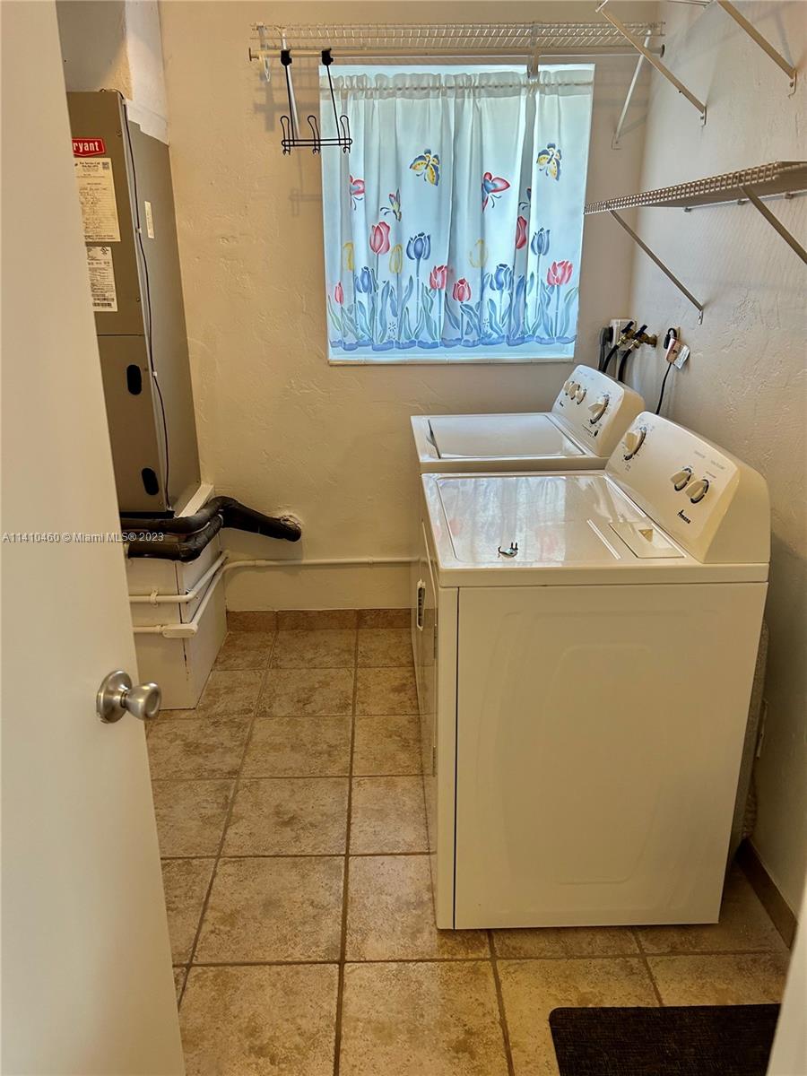 3790 Polk Street Hollywood, FL 33021 - Photo 17 of 23 a utility room with a refrigerator
