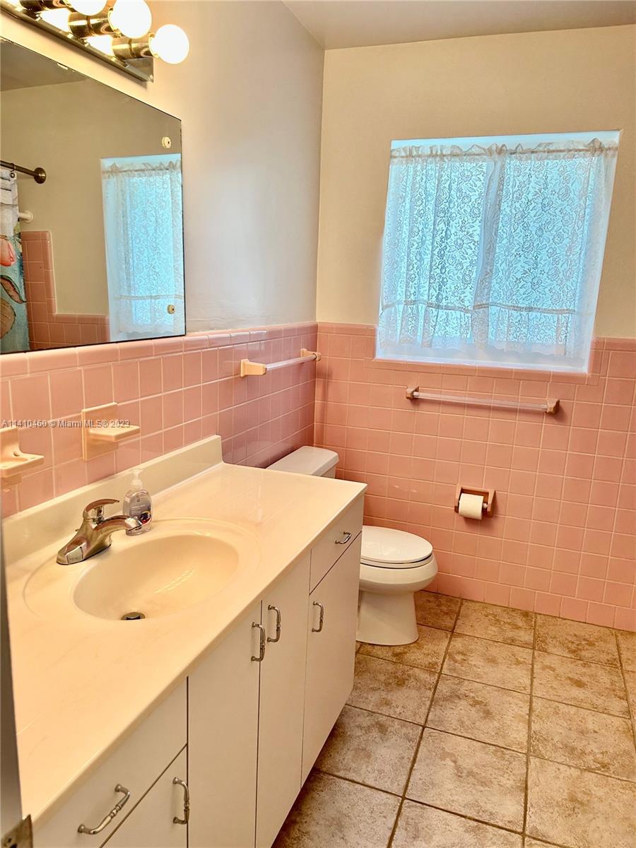 3790 Polk Street Hollywood, FL 33021 - Photo 18 of 23 a bathroom with a sink a toilet and mirror