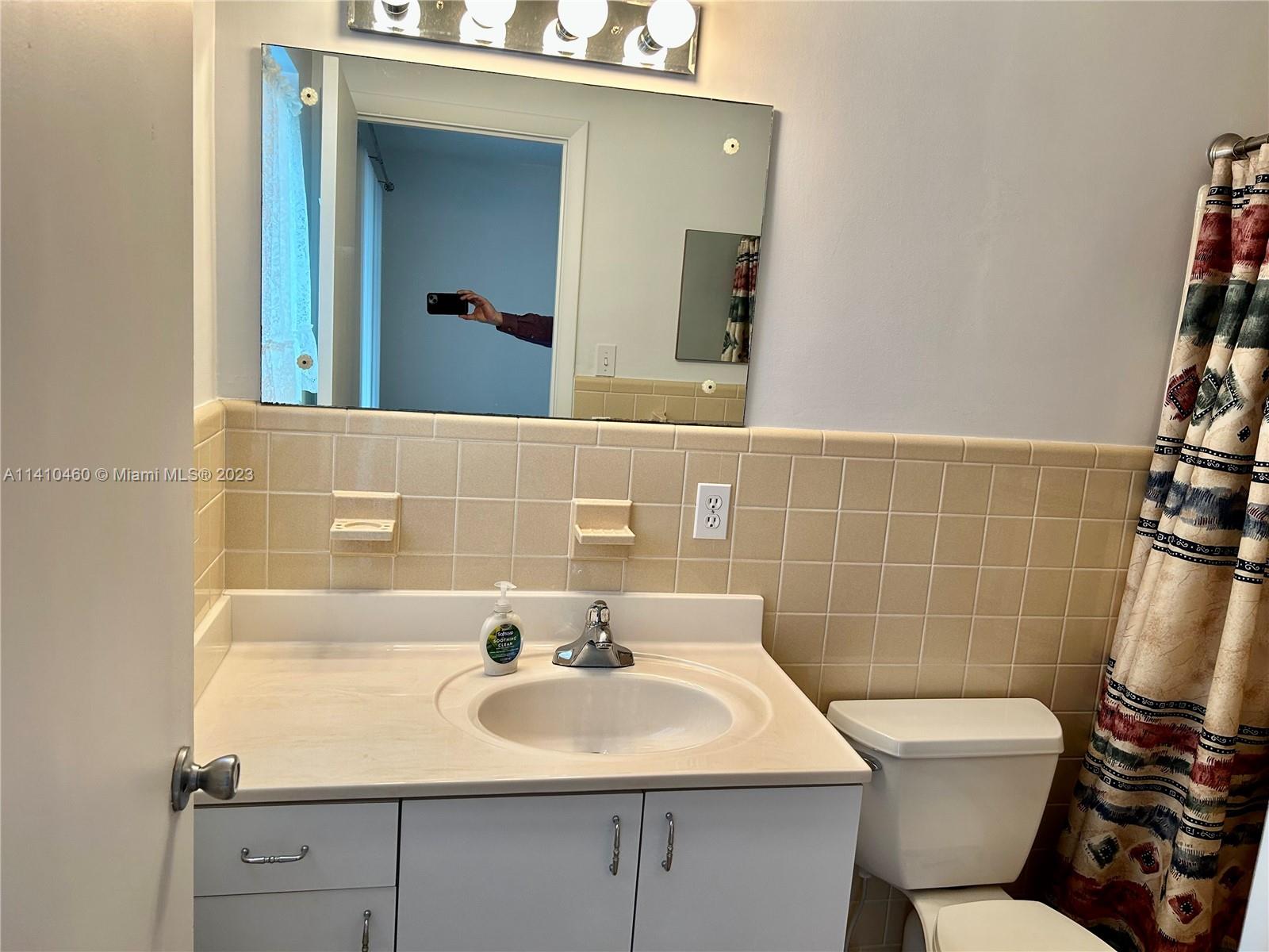 3790 Polk Street Hollywood, FL 33021 - Photo 20 of 23 a bathroom with a sink and a mirror