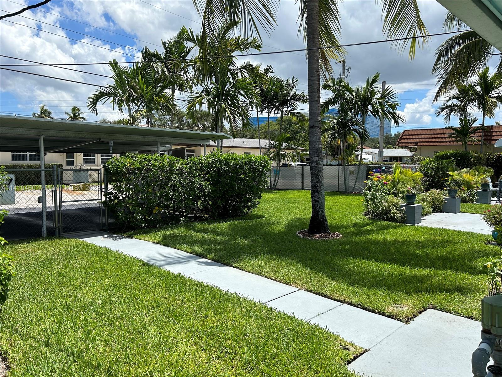 3790 Polk Street Hollywood, FL 33021 - Photo 6 of 23 a front view of a house with a yard