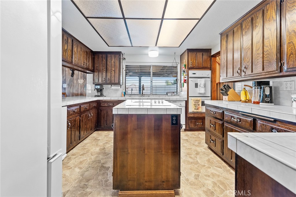 18200 Van Buren Boulevard Riverside, CA 92508 - Photo 20 of 56 a kitchen with stainless steel appliances granite countertop a stove a sink dishwasher and cabinets