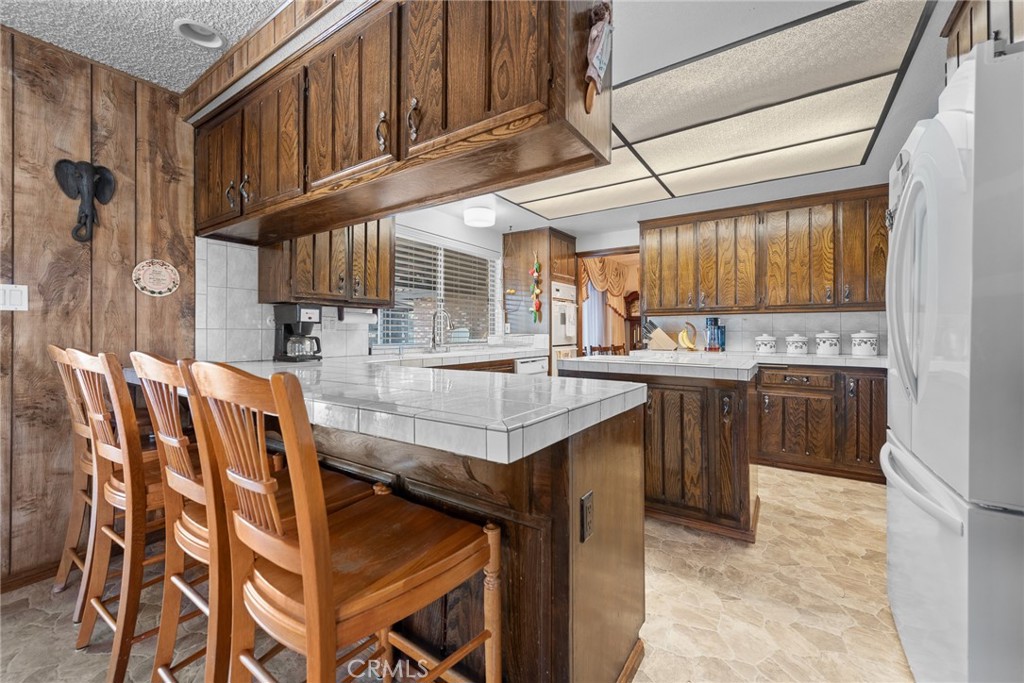 18200 Van Buren Boulevard Riverside, CA 92508 - Photo 22 of 56 a kitchen with stainless steel appliances granite countertop a table chairs in it and a window