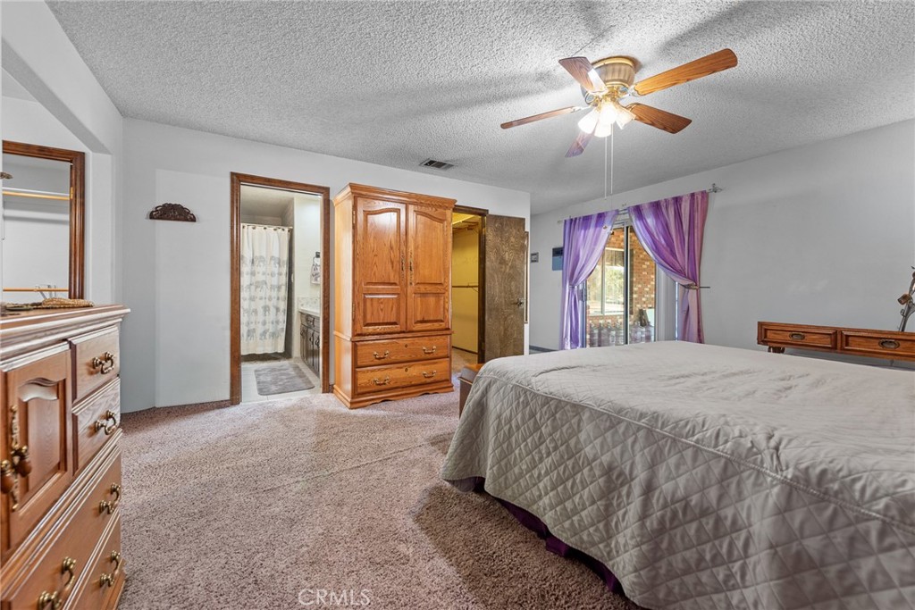 18200 Van Buren Boulevard Riverside, CA 92508 - Photo 24 of 56 a bedroom with a bed and a chandelier