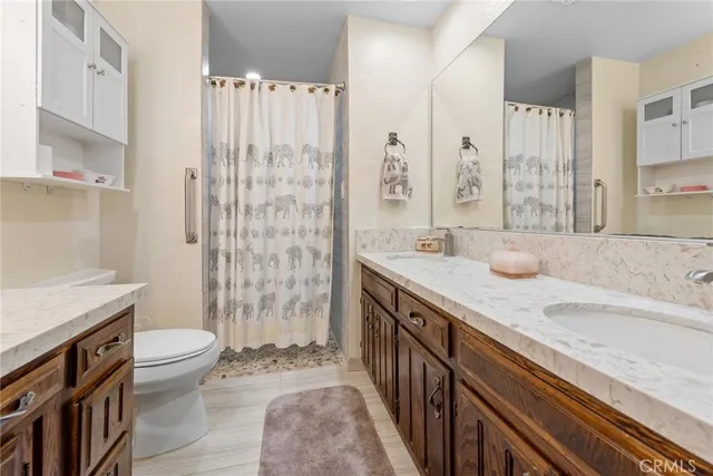 a spacious bedroom with a bed and a chandelier