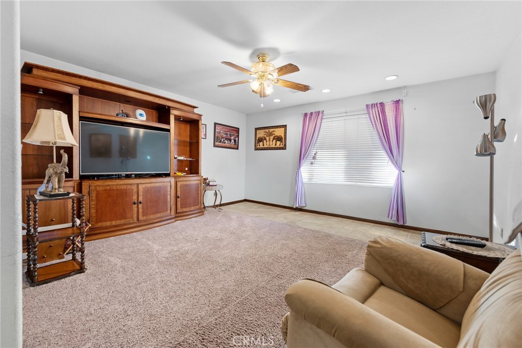 18200 Van Buren Boulevard Riverside, CA 92508 - Photo 27 of 56 a living room with furniture and a flat screen tv