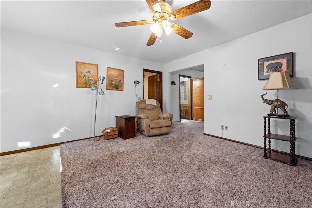 18200 Van Buren Boulevard Riverside, CA 92508 - Photo 28 of 56 a view of a livingroom with lounge chair and a ceiling fan