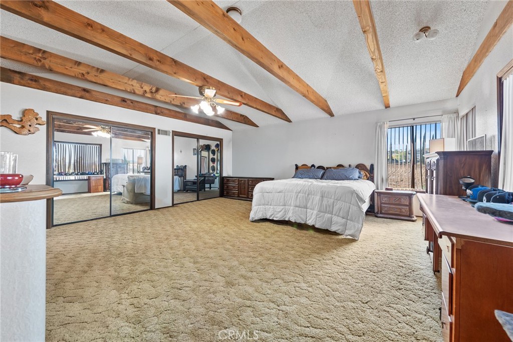 18200 Van Buren Boulevard Riverside, CA 92508 - Photo 35 of 56 a bedroom with a large bed and a large mirror