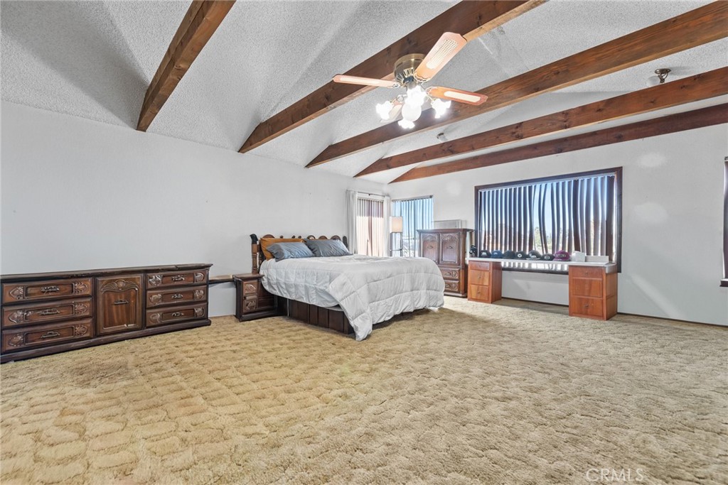 18200 Van Buren Boulevard Riverside, CA 92508 - Photo 36 of 56 a bedroom with a large bed and a chandelier