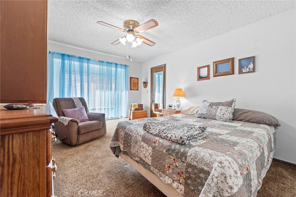 18200 Van Buren Boulevard Riverside, CA 92508 - Photo 8 of 56 a spacious bedroom with a bed and a chandelier