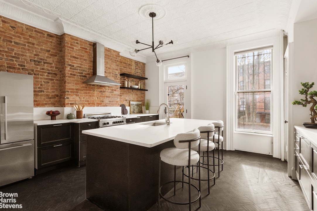 738 Madison Street Brooklyn, NY 11221 - Photo 4 of 14 a kitchen that has a cabinets a sink and a stove