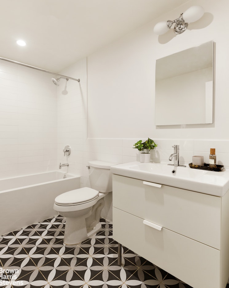 738 Madison Street Brooklyn, NY 11221 - Photo 6 of 14 a bathroom with a sink toilet a mirror and shower