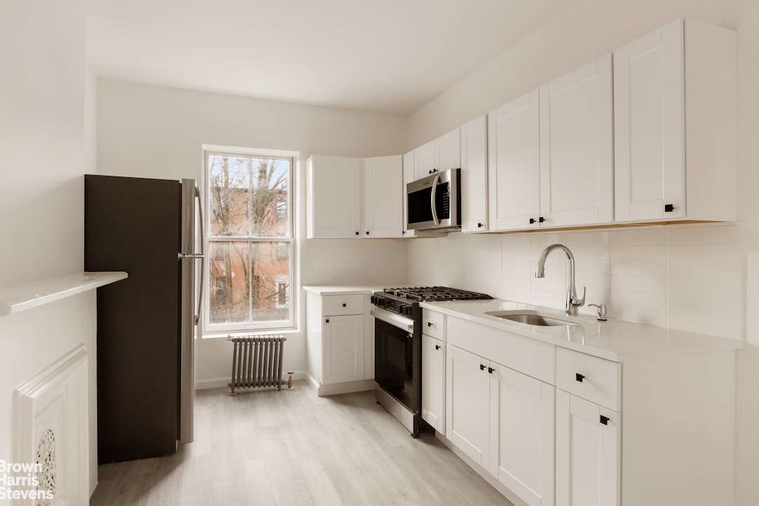 738 Madison Street Brooklyn, NY 11221 - Photo 9 of 14 a kitchen with stainless steel appliances granite countertop a stove a sink and a refrigerator