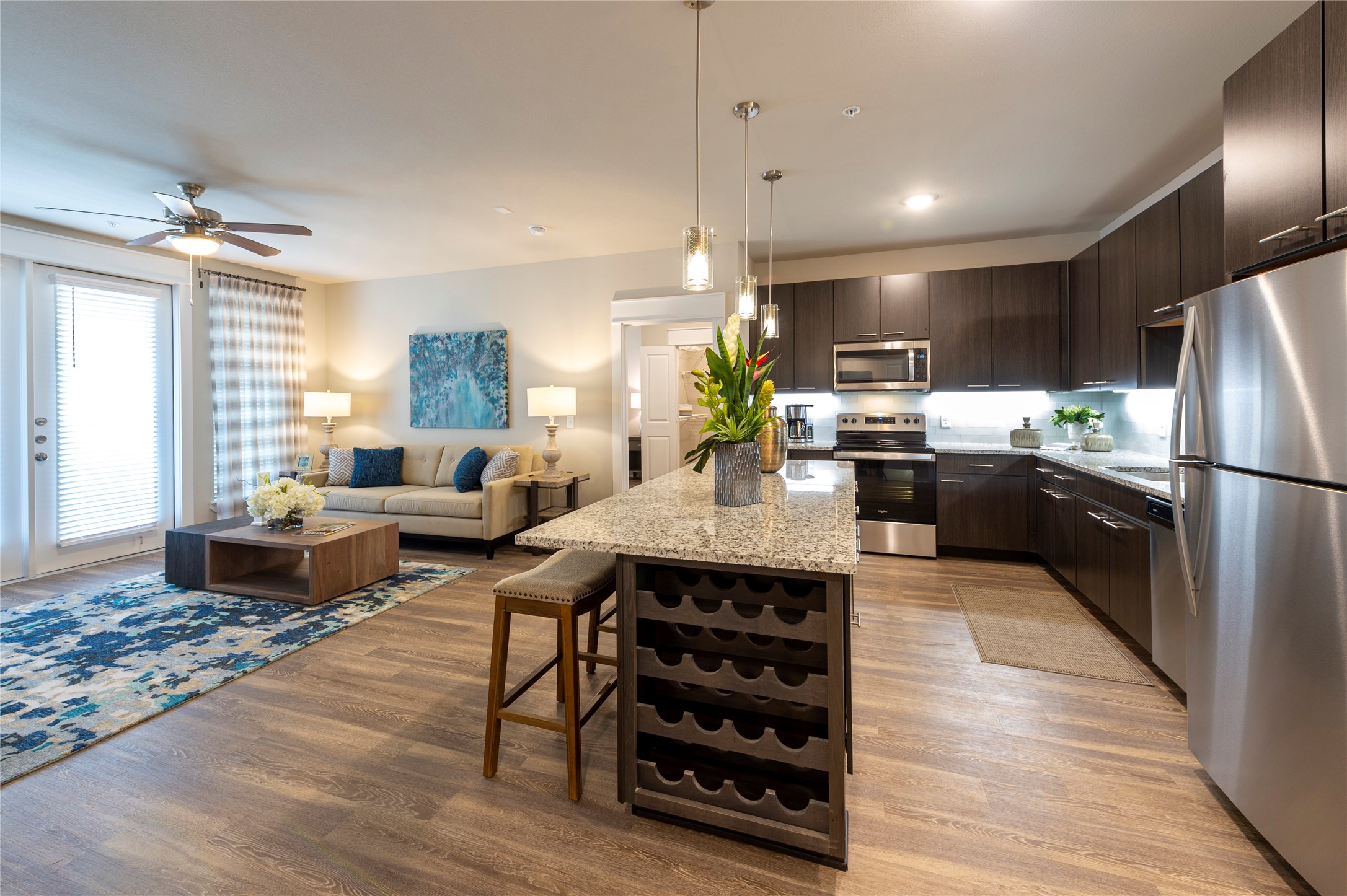 1616 Partnership Way, Unit 2104 Katy, TX 77449 - Photo 11 of 22 a kitchen with refrigerator a stove and a wooden floors