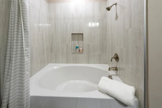 a bathroom with a granite countertop sink a toilet and a mirror