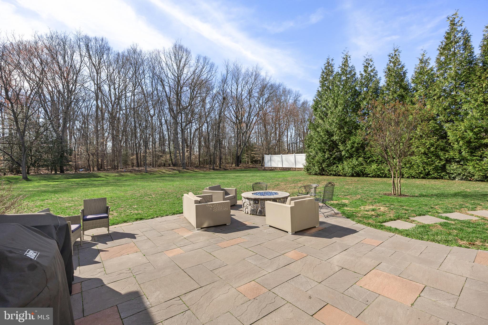15 Millway Road Lumberton, NJ 08048 - Photo 50 of 66 a view of a backyard with table and chairs potted plants and large trees