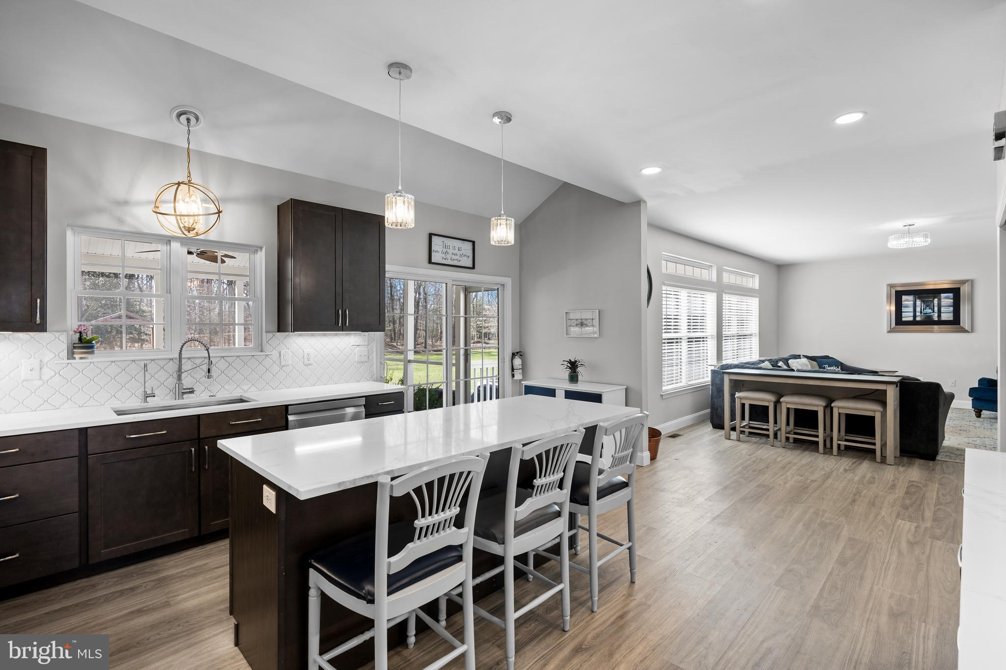 15 Millway Road Lumberton, NJ 08048 - Photo 8 of 66 a kitchen with stainless steel appliances a dining table chairs and wooden floor