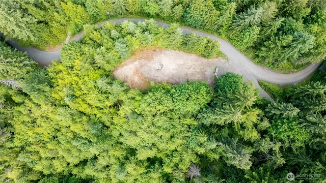 an aerial view of a residential houses with green space
