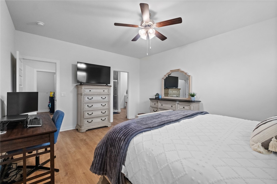 2105 Oliver Street Pea Ridge, AR 72751 - Photo 13 of 26 Interior space featuring wood-finish flooring, white walls, and a ceiling fan with integrated lighting
