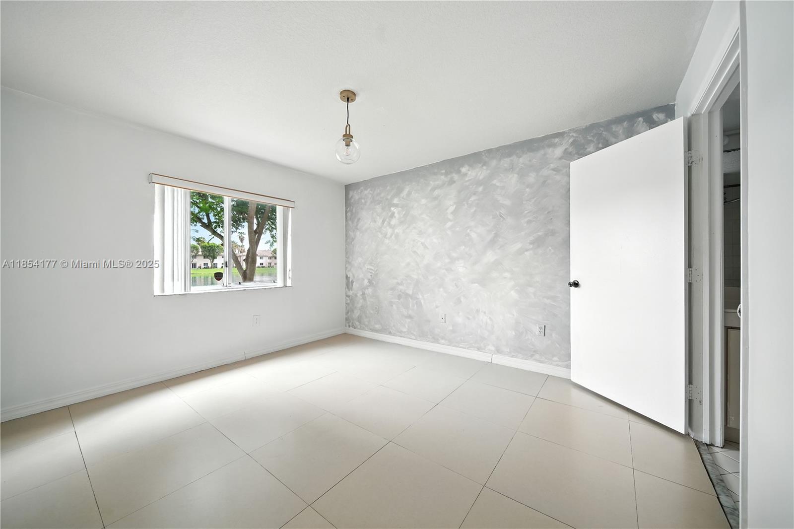 1270 Southeast 26th Street, Unit 101 Homestead, FL 33035 - Photo 12 of 18 an empty room with windows and closet