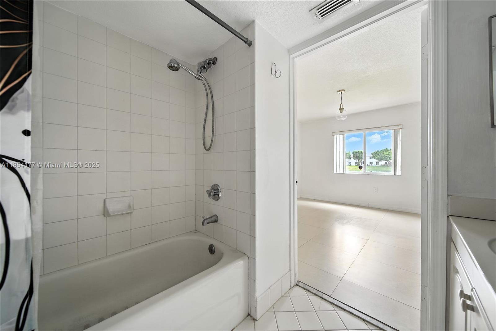 1270 Southeast 26th Street, Unit 101 Homestead, FL 33035 - Photo 14 of 18 a bathroom with a bathtub and a shower