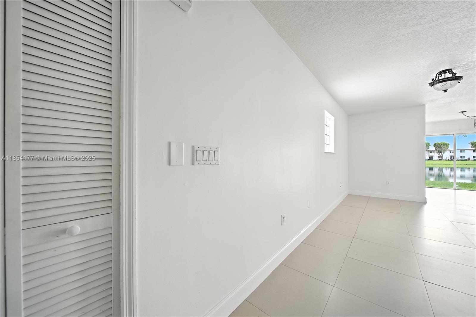1270 Southeast 26th Street, Unit 101 Homestead, FL 33035 - Photo 6 of 18 a view of a hallway to rooms and wooden floor