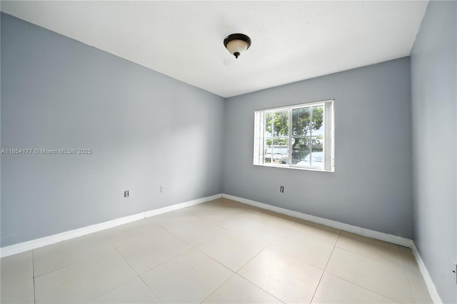 1270 Southeast 26th Street, Unit 101 Homestead, FL 33035 - Photo 7 of 18 an empty room with windows