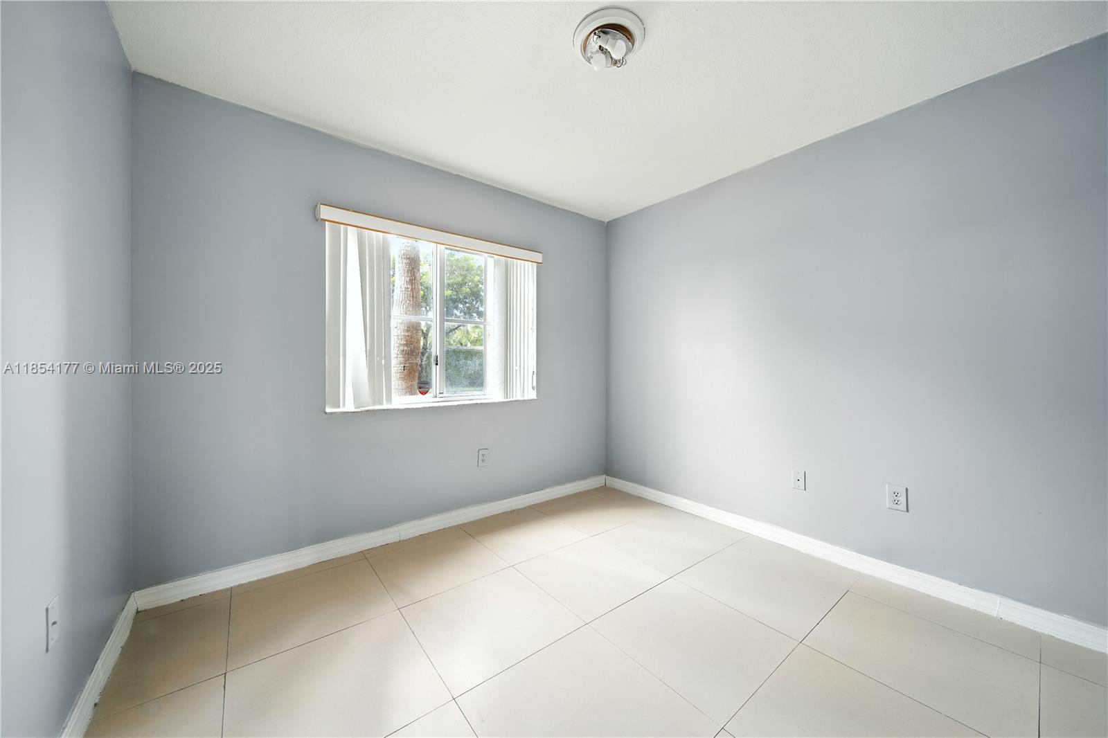 1270 Southeast 26th Street, Unit 101 Homestead, FL 33035 - Photo 8 of 18 an empty room with windows