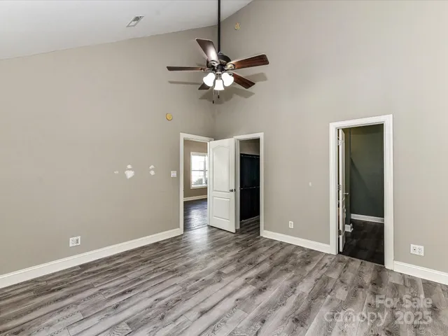 a view of a livingroom with a ceiling fan and window