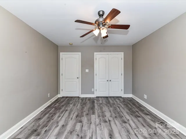 a view of a room with wooden floor