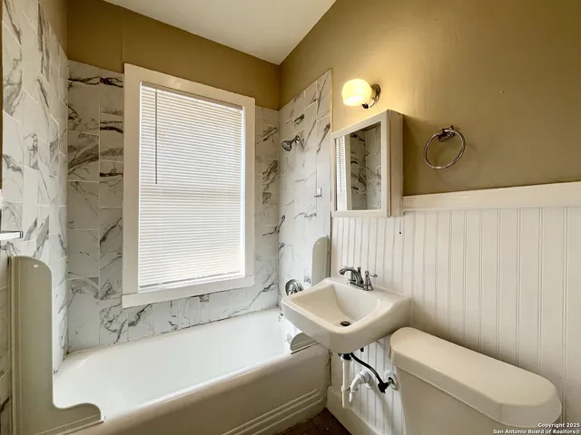 a bathroom with a sink a toilet and bathtub