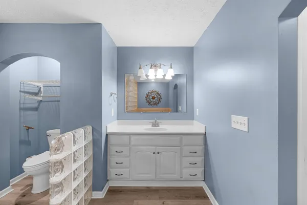 a bathroom with a sink toilet and a mirror