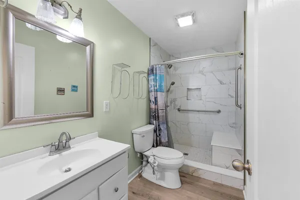 a bathroom with a sink toilet and shower