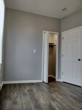 a view of an empty room and closet area