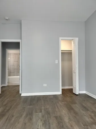 a view of an empty room and wooden floor