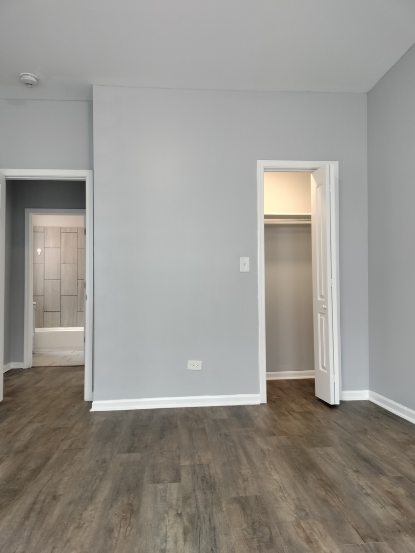 6601 South Green Street, Unit 8232 Chicago, IL 60621 - Photo 7 of 12 a view of an empty room and wooden floor