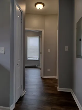 an empty room with wooden floor and closet