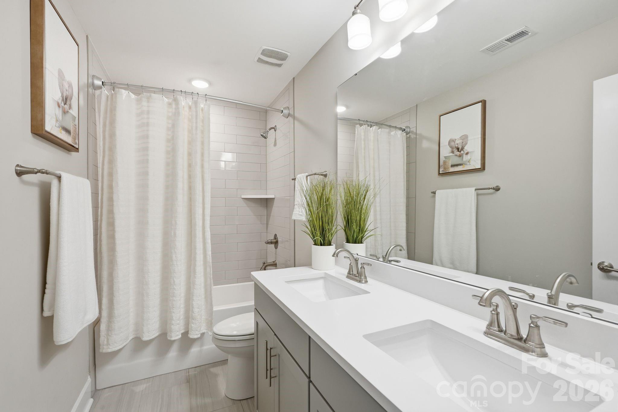 1086 Weir Court Fort Mill, SC 29708 - Photo 28 of 40 a bathroom with a double vanity sink toilet and a mirror