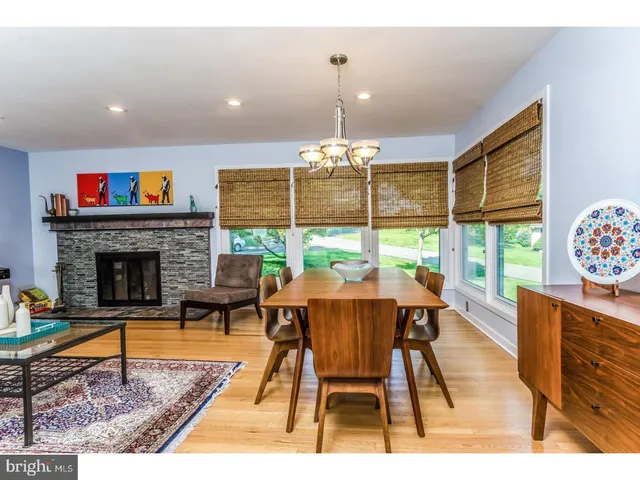 a living room with furniture a rug and a fireplace