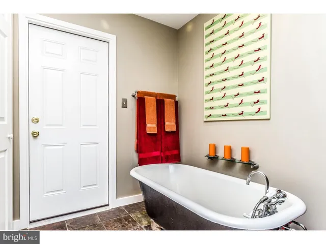 a bathroom with a tub and shower
