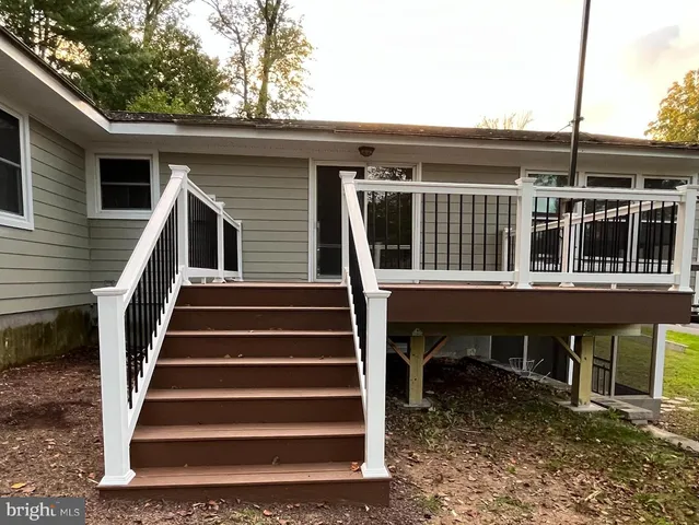a view of a house with large windows and stairs