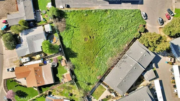 an aerial view of a house with garden space and street view