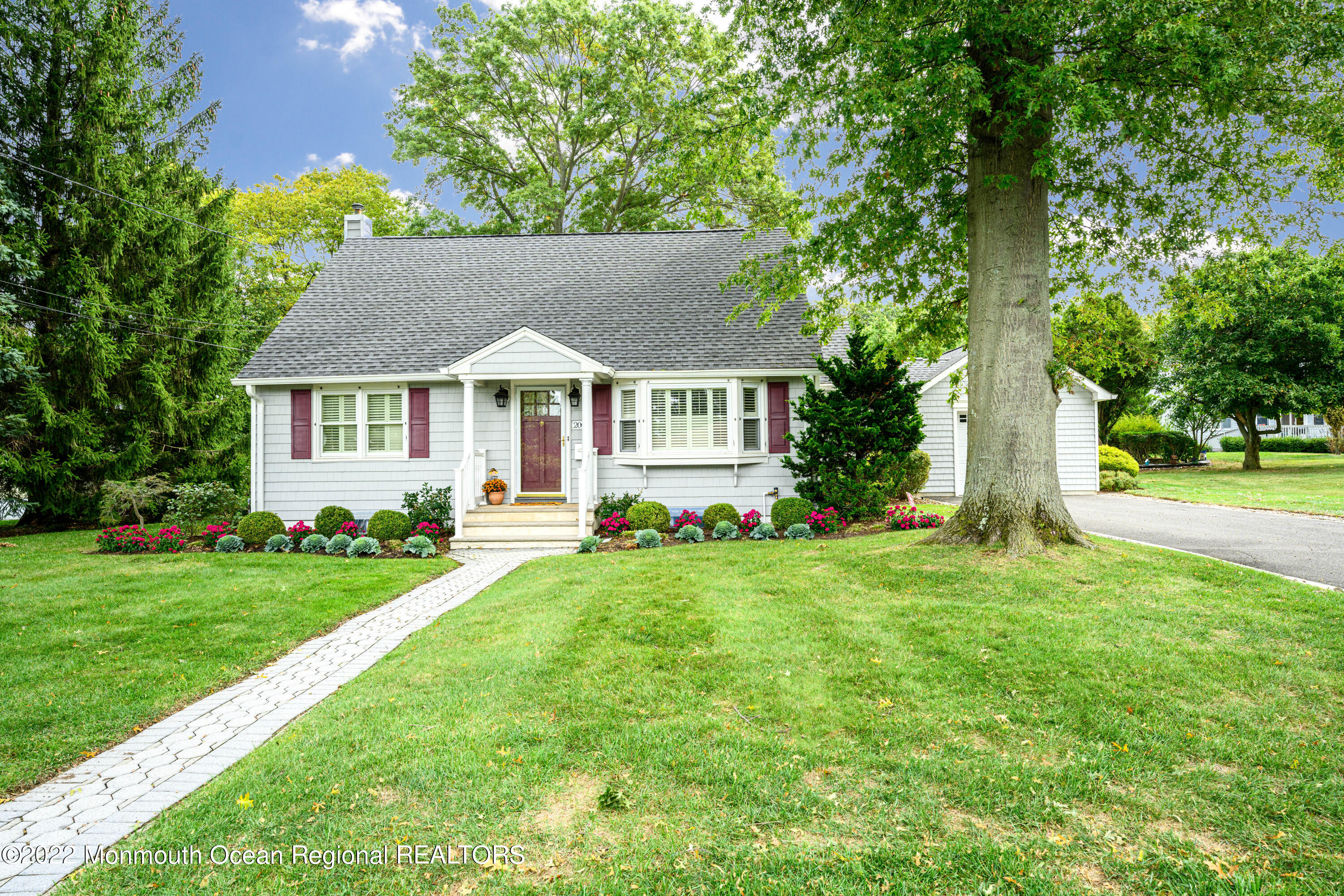 2002 Nassau Drive Spring Lake, NJ 07762 - Photo 2 of 43 a front view of a house with a yard and trees
