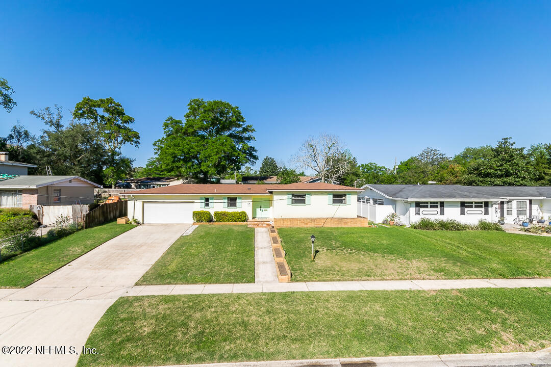 3846 Bess Road Jacksonville, FL 32277 - Photo 14 of 18 a view of yard with swimming pool and trees in the background