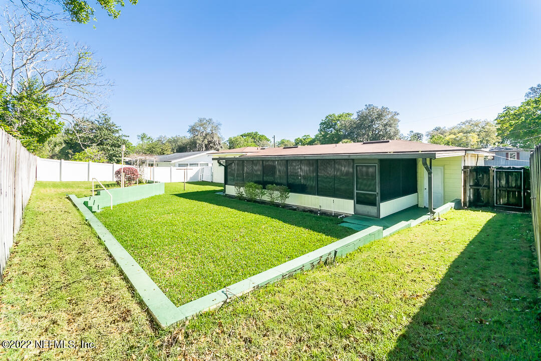 3846 Bess Road Jacksonville, FL 32277 - Photo 16 of 18 a view of a backyard with a garden and deck