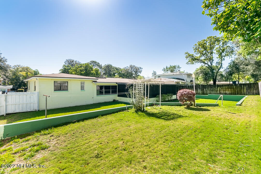 3846 Bess Road Jacksonville, FL 32277 - Photo 17 of 18 a view of a house with swimming pool and a yard