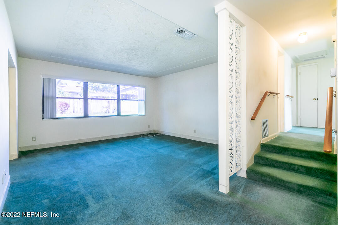 3846 Bess Road Jacksonville, FL 32277 - Photo 6 of 18 a view of a room with stairs and a window