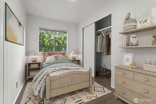 a bed sitting in a bedroom next to a window